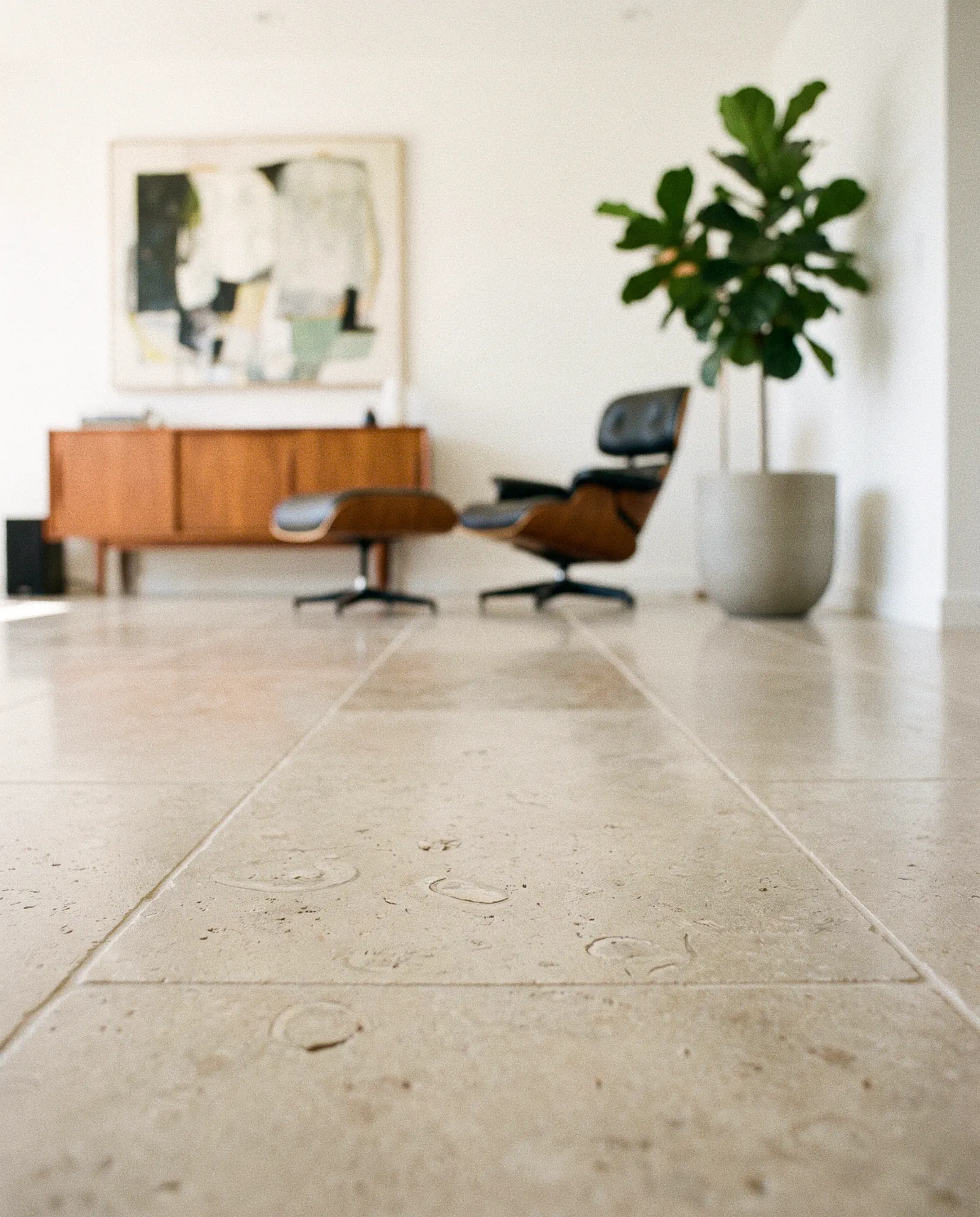 Limestone restoration in Tampa: a honed limestone floor with fossil shell inclusions running through a Tampa Bay living room