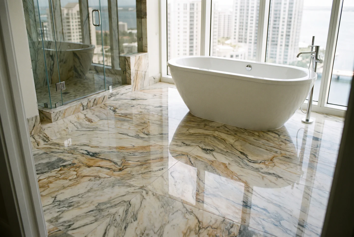 A polished marble bathroom floor in a Harbour Island high-rise condo overlooking the water