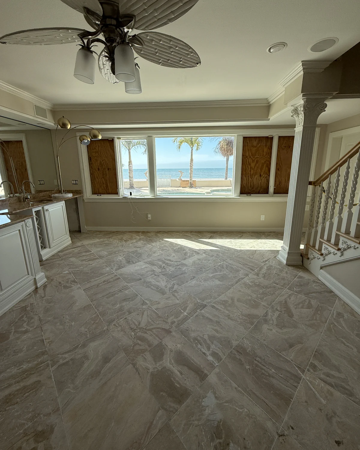 Marble floor honed flat to remove scratches, before polishing, in a Tampa Bay beachfront home