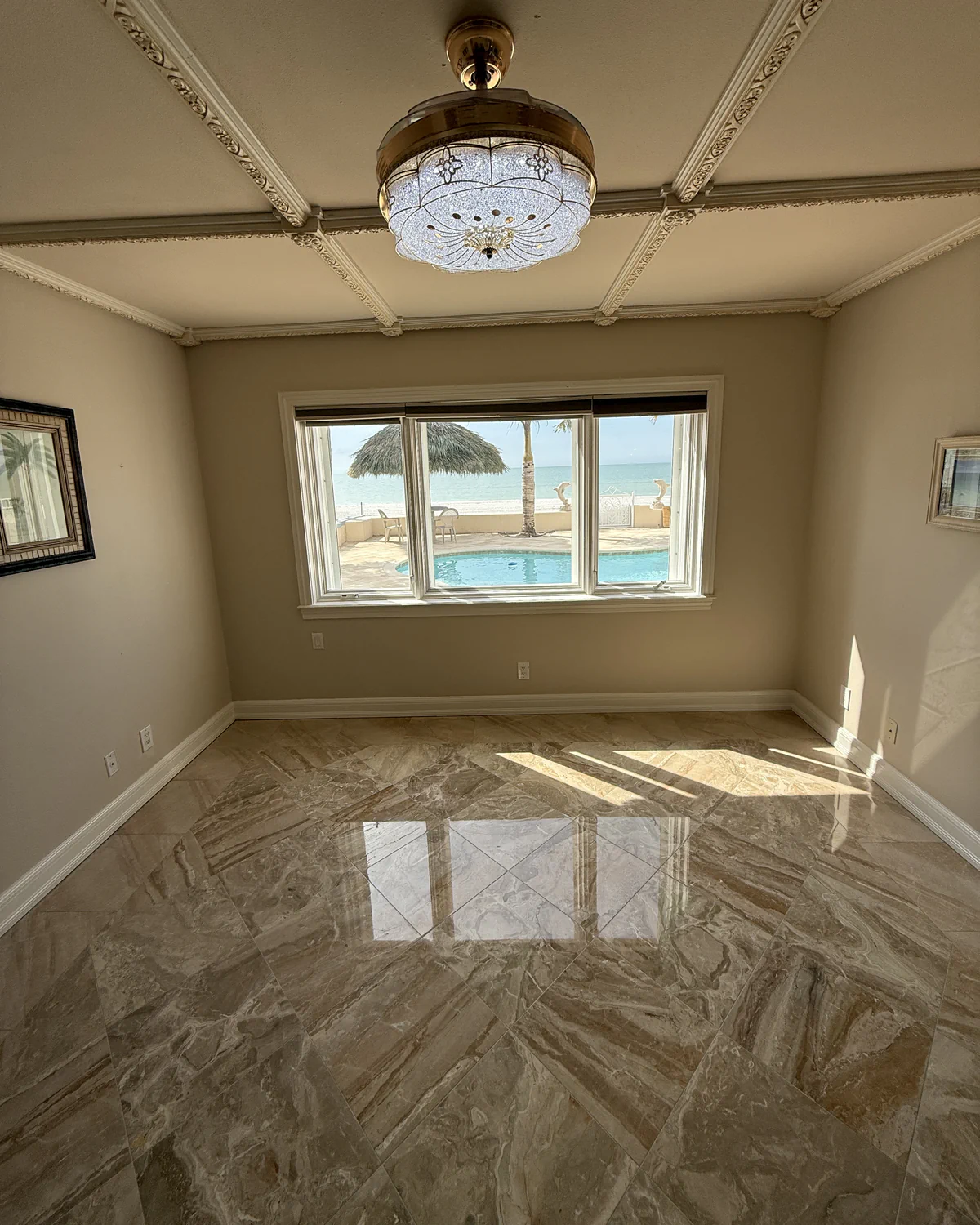 Finished marble floor under a coffered ceiling after honing, polishing, crystallizing and sealing in a Tampa Bay home