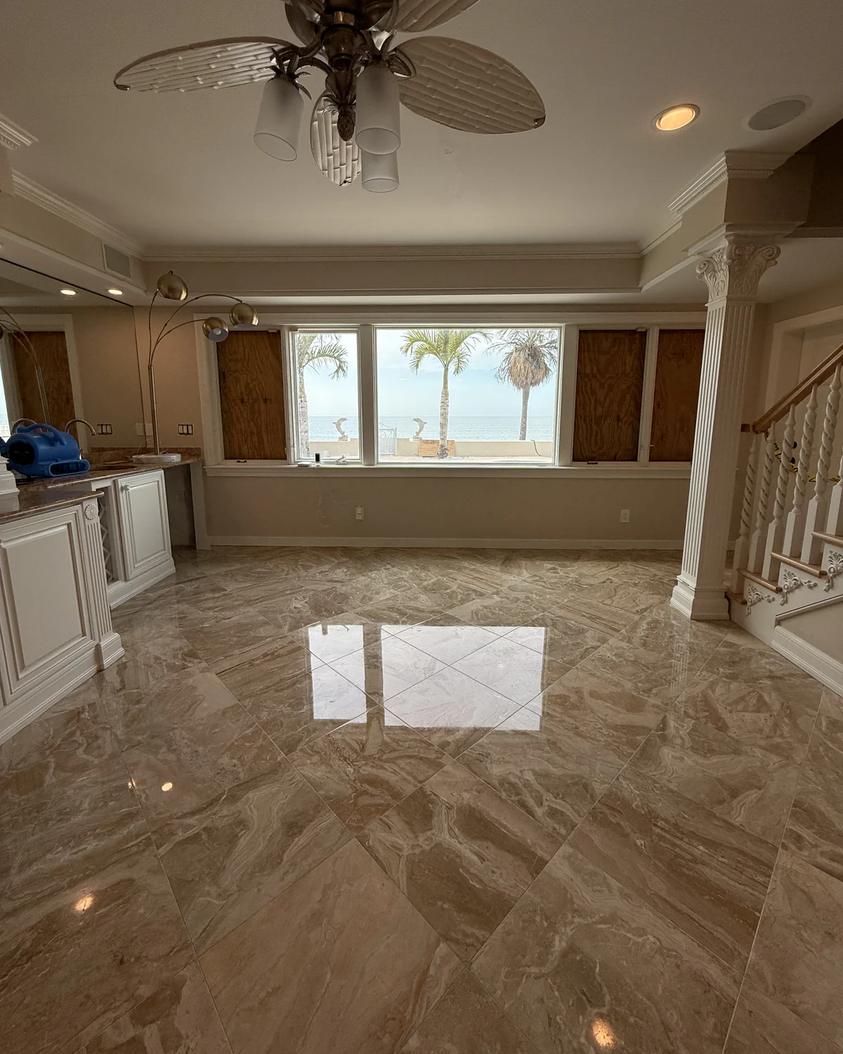 Marble floor returning a clean window reflection after honing, polishing, crystallizing and sealing in Tampa Bay