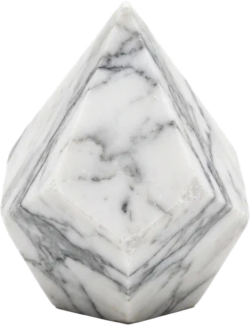 A faceted specimen of Carrara marble showing its white ground and soft grey veining