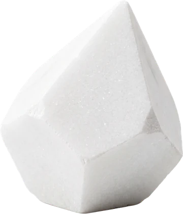 A faceted specimen of white marble showing the near unveined brightness of Statuario and Thassos
