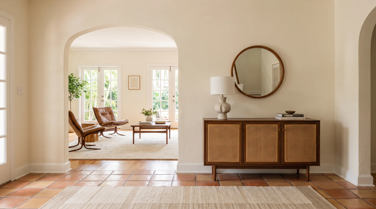 Saltillo tile entry hall with a plaster arch in a Tampa Bay home