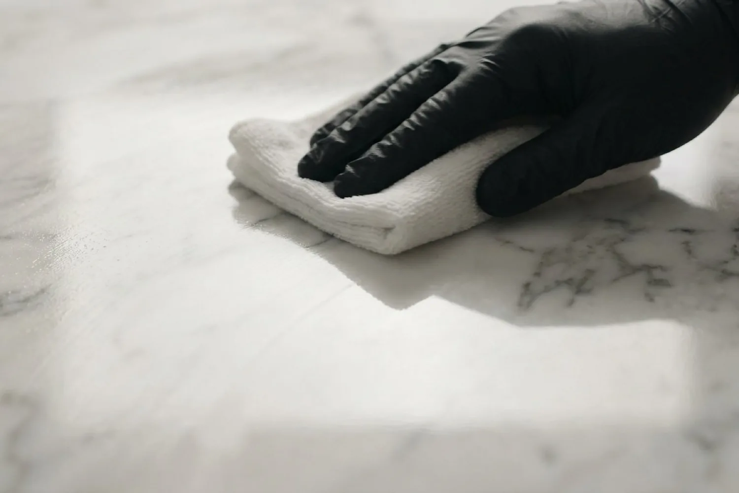 Applying penetrating sealer to a polished marble countertop in Tampa Bay