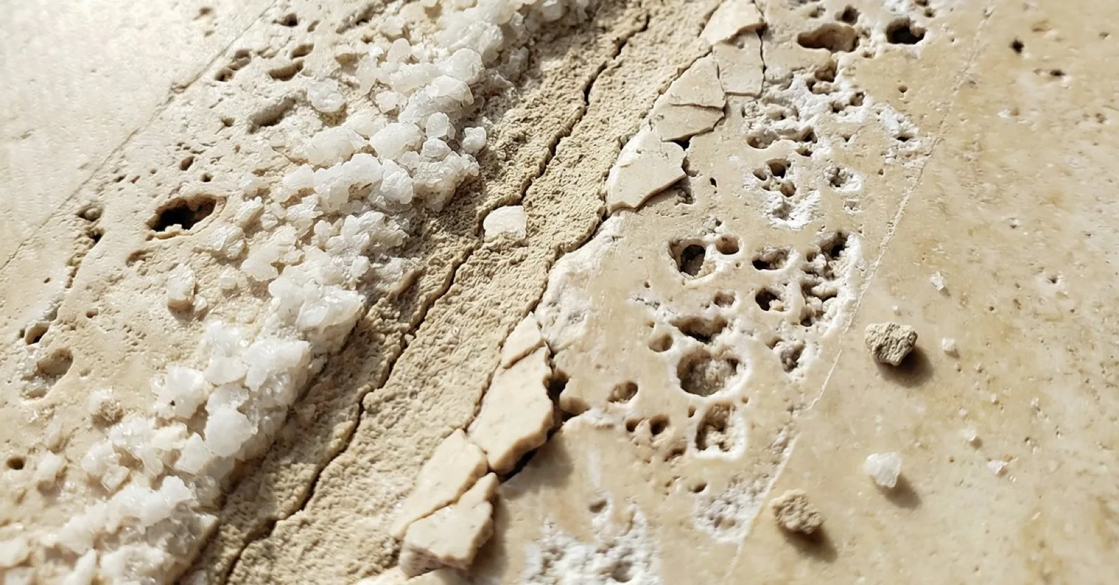 White efflorescence on outdoor travertine in Tampa Bay