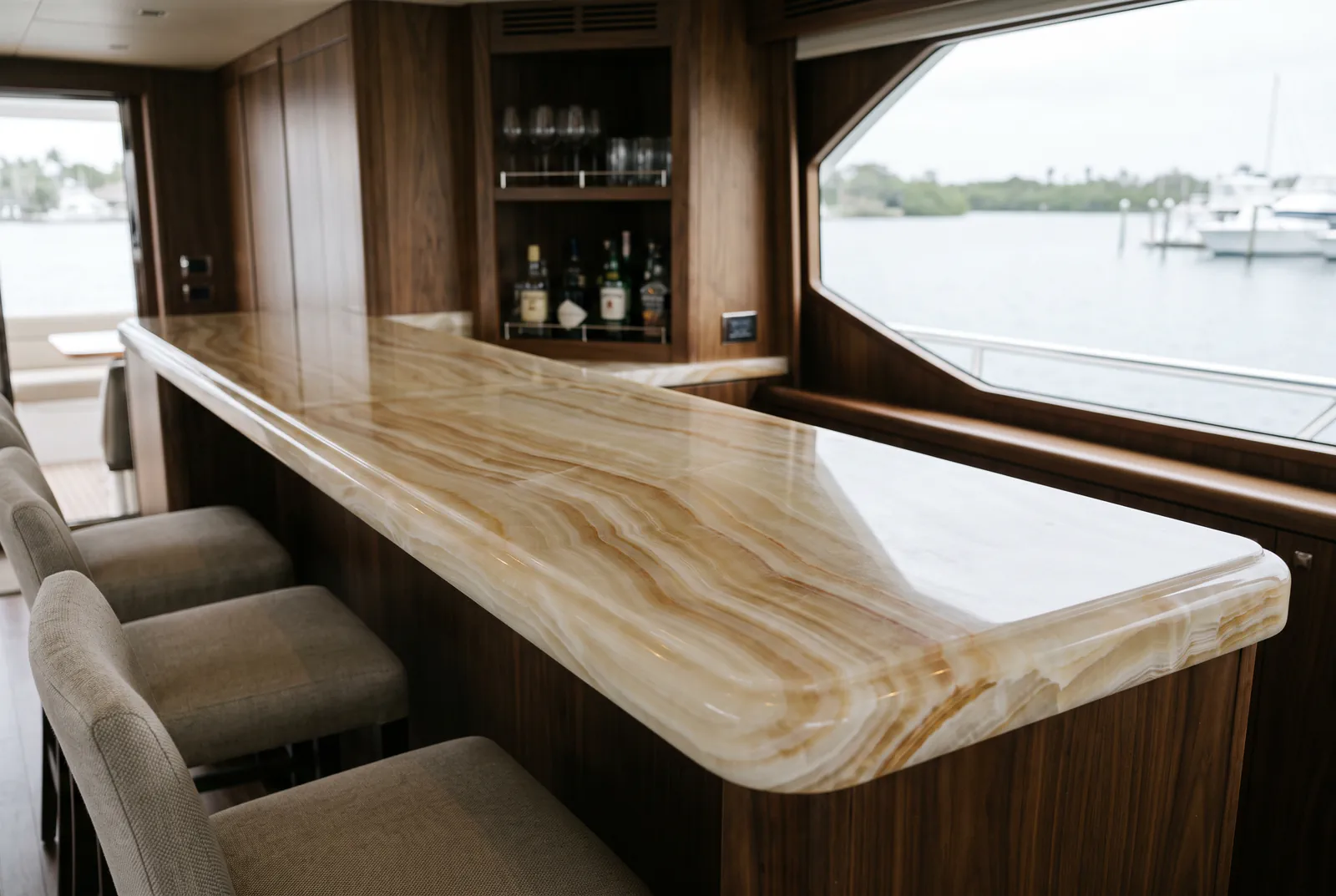 Stone countertop polishing in Tampa: a polished onyx bar top in the salon of a motor yacht at a Tampa Bay marina